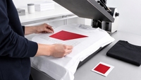 Garment decorator aligning a heat transfer on a blank T-shirt before printing